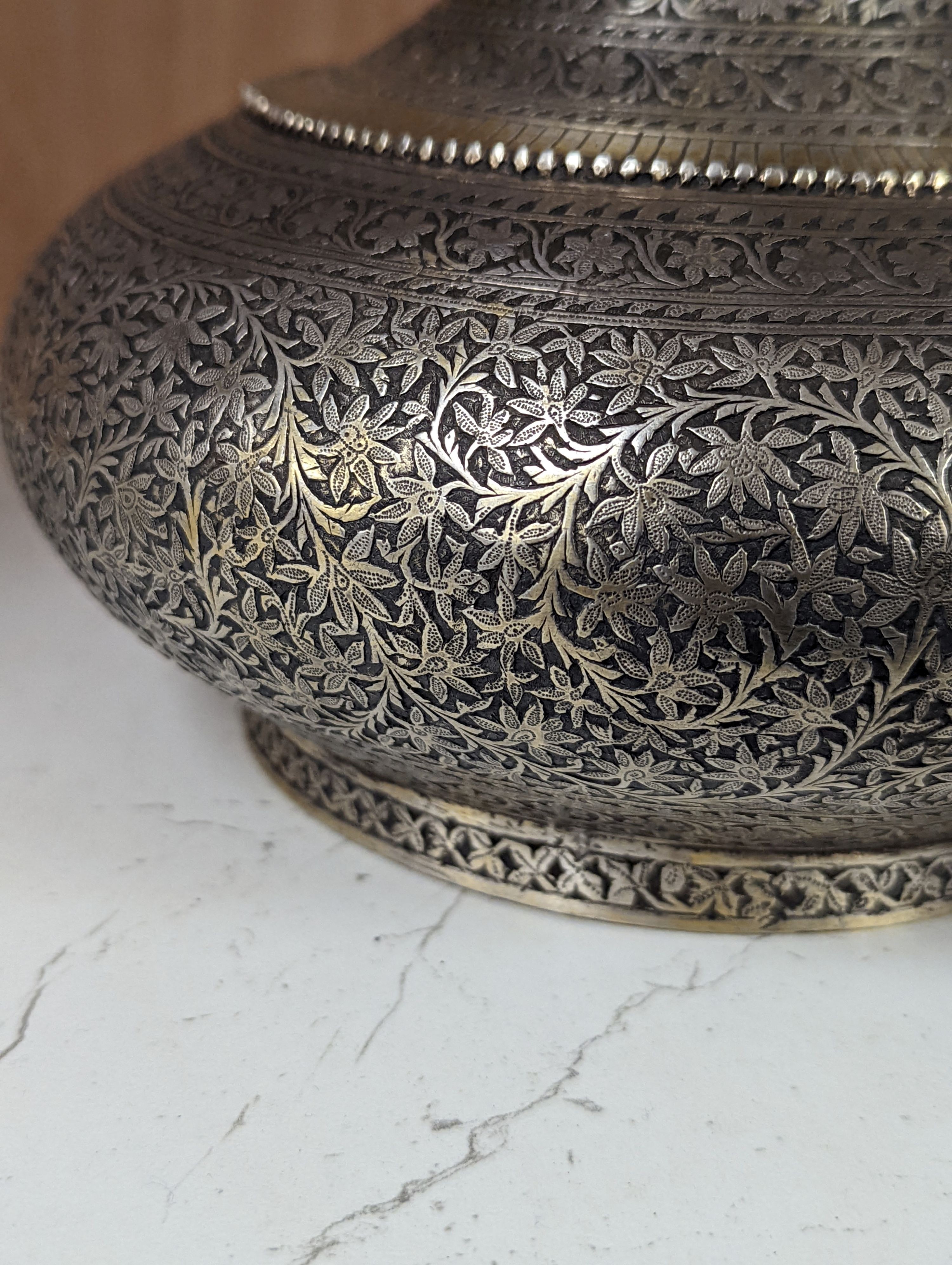 A 19th century North Indian silver surahi with engraved shawl decoration 30cm